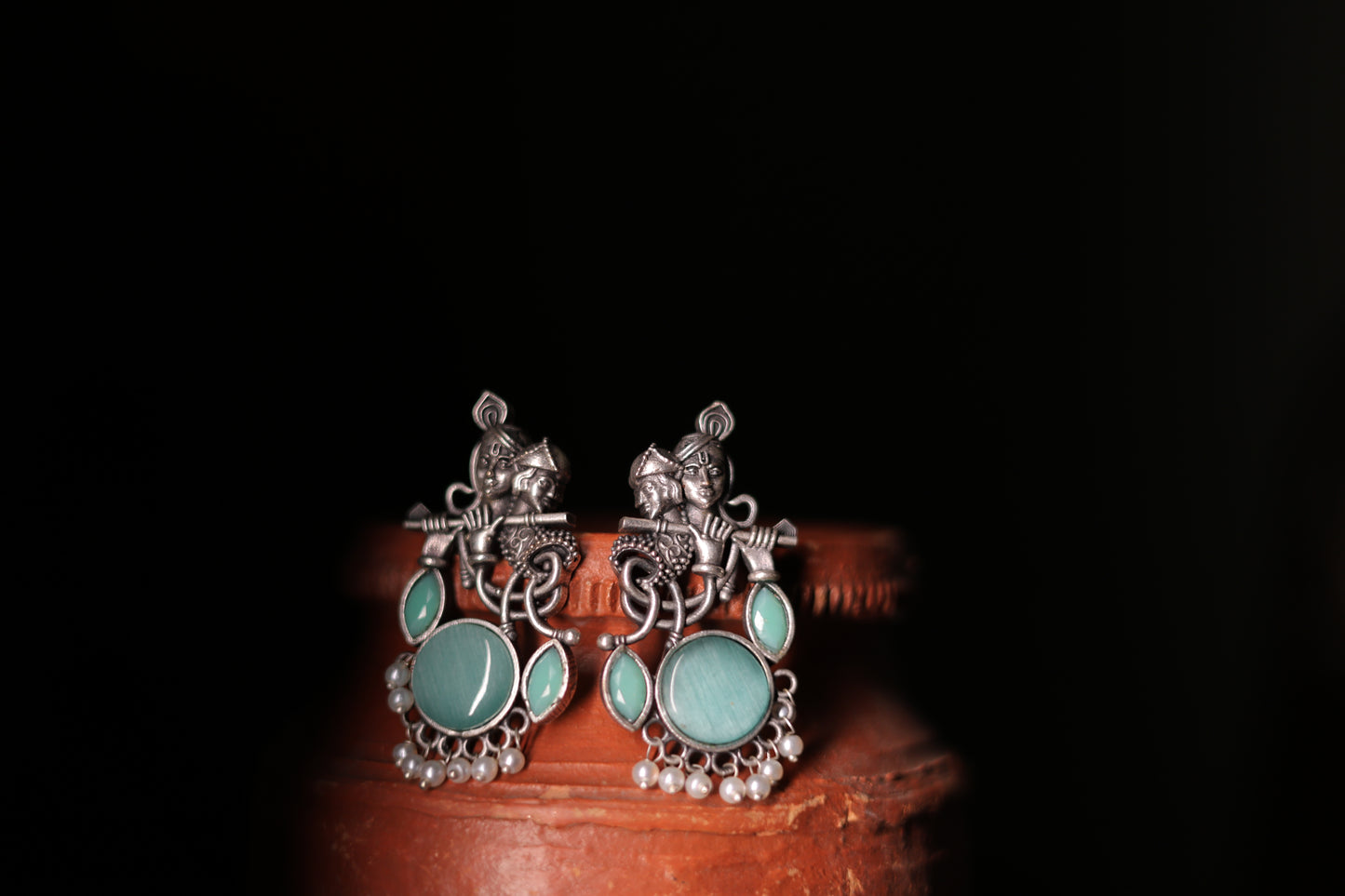 Silver replica krishna stud earrings