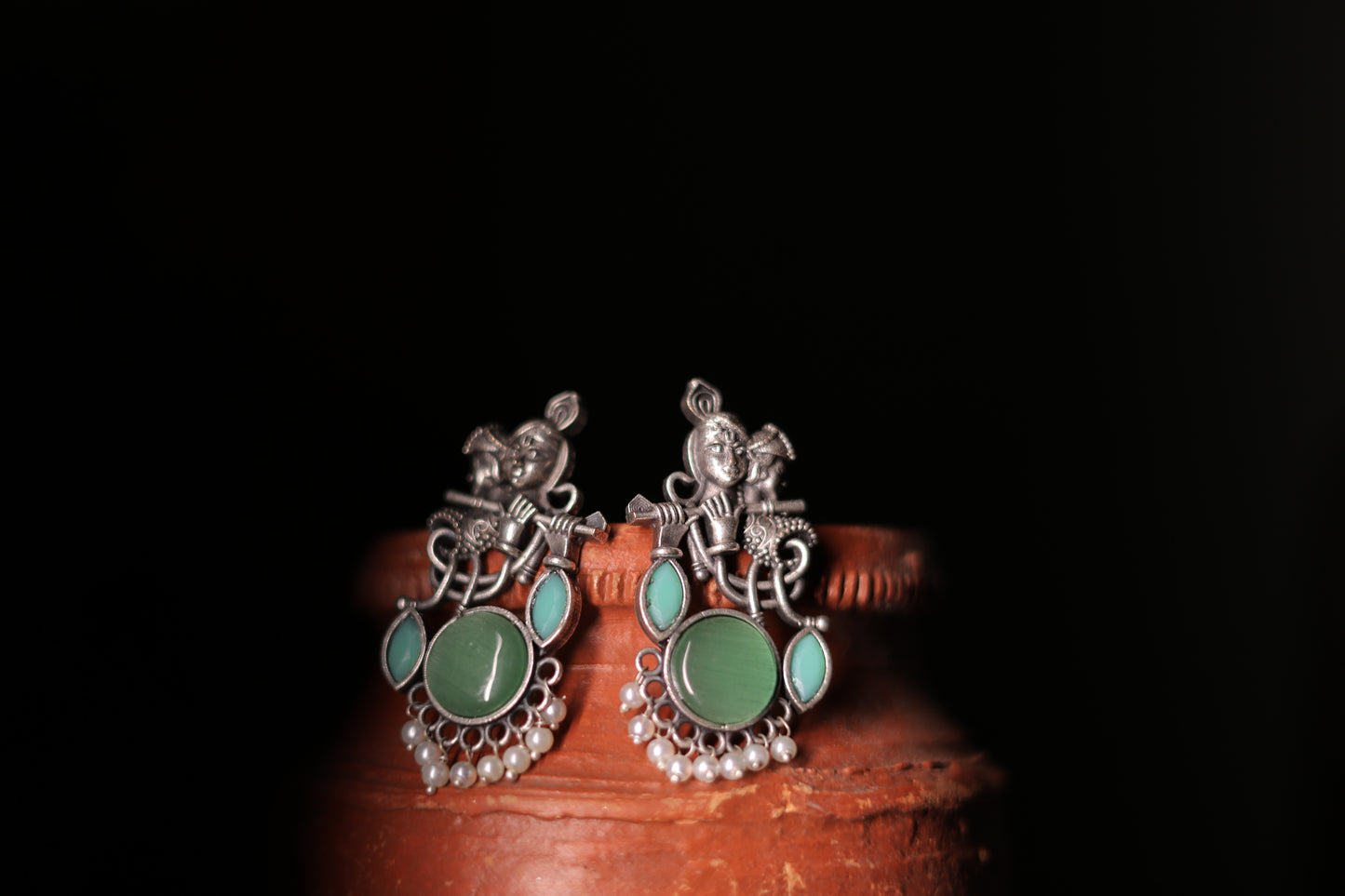 Silver replica krishna stud earrings