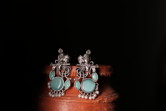 Silver replica krishna stud earrings
